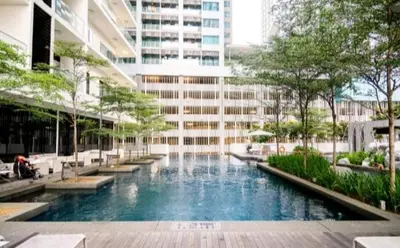 a building with a swimming pool in front of a building at 188 Suites KLCC by Signature Apartment in Kuala Lumpur