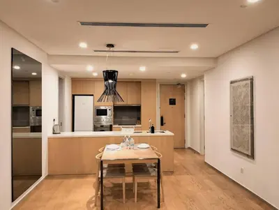 a kitchen with a table in the middle of a room at 188 Suites KLCC by Signature Apartment in Kuala Lumpur