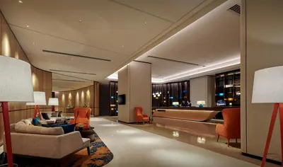 a lobby of a hotel with couches and chairs at Amari Kuala Lumpur in Kuala Lumpur