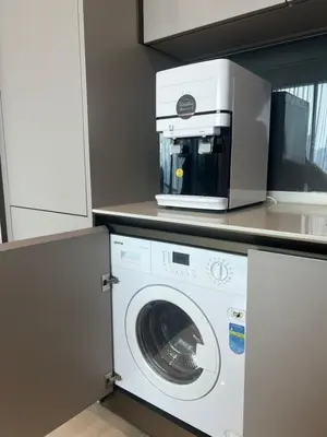 a microwave sitting on top of a washing machine at Merdeka Tower 118 Chinatown TRX at Opus in Kuala Lumpur