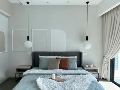 a bedroom with a large bed with white walls at The Ooak Suites and Residence@ Kiara 163 in Kuala Lumpur