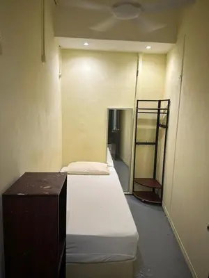 a room with three beds and a shelf in it at RHV Bukit Bintang , Kuala Lumpur in Kuala Lumpur