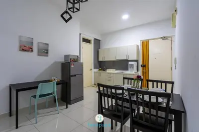 a kitchen with a table and chairs and a refrigerator at Lovely 4-bedroom condo with pool for 6 pax - Cheras in Kuala Lumpur