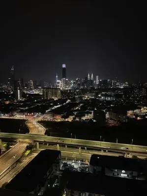 a view of a city at night with a freeway at Lovely 4-bedroom condo with pool for 6 pax - Cheras in Kuala Lumpur