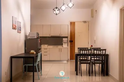 a kitchen and dining room with a table and chairs at Lovely 4-bedroom condo with pool for 6 pax - Cheras in Kuala Lumpur