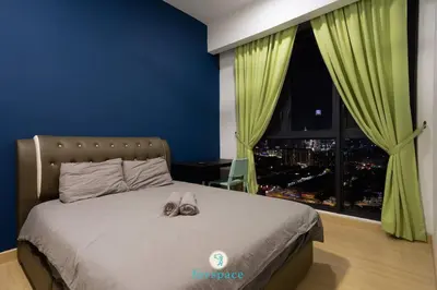 a bedroom with a bed with a pair of shoes on it at Lovely 4-bedroom condo with pool for 6 pax - Cheras in Kuala Lumpur