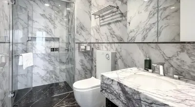 a marble bathroom with a sink and a toilet at Platinum 2 by DM Suites KLCC , Kuala Lumpur in Kuala Lumpur