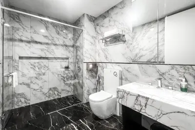 a black and white bathroom with a toilet and a sink at Platinum 2 by DM Suites KLCC , Kuala Lumpur in Kuala Lumpur