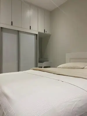 a bedroom with a white bed and white cabinets at Lovely Continew Residence 2 Bedrooms - KL in Kuala Lumpur