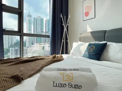 a hotel room with a king size bed with a large window at The Robertson Bukit Bintang Luxe Suites in Kuala Lumpur