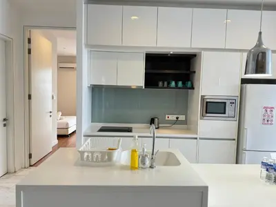 a white kitchen with a sink and a refrigerator at The Face Platinum Suites KLCC in Kuala Lumpur