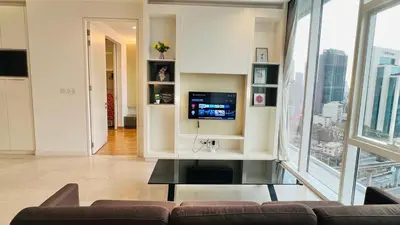a living room with a couch and a tv at The Face Platinum Suites KLCC in Kuala Lumpur