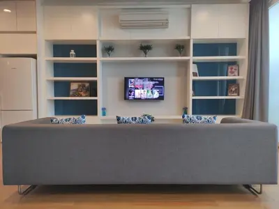 a living room with a couch and a tv at The Face Platinum Suites KLCC in Kuala Lumpur