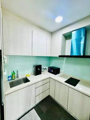 a kitchen with white cabinets and a sink at Velocity Residence at Sunway mall in Kuala Lumpur