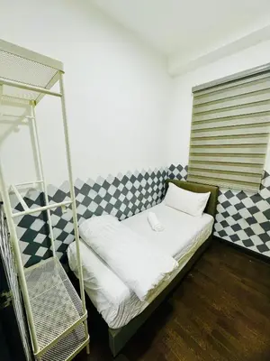 a bedroom with a bunk bed with a checkered wall at Velocity Residence at Sunway mall in Kuala Lumpur