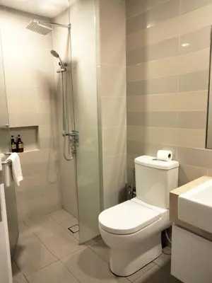 a bathroom with a toilet and a glass shower at Oneiro One Bukit Ceylon in Kuala Lumpur