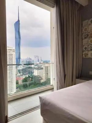 a bedroom with a large window with a view of a city at Oneiro One Bukit Ceylon in Kuala Lumpur