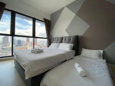 two beds in a bedroom with a geometric wall at Happy Continew Residence 2 Bedrooms - TRX KL in Kuala Lumpur