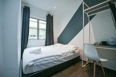 a bedroom with a canopy bed and a desk at Meta Hotel in Kuala Lumpur