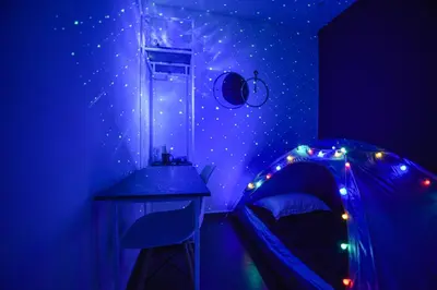 a room with a bed and a ceiling with stars at Meta Hotel in Kuala Lumpur