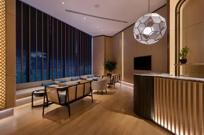 a lobby with a bar and a table and chairs at M Resort & Hotel Kuala Lumpur in Kuala Lumpur