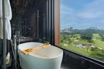 a bathroom with a bath tub and a large window at M Resort & Hotel Kuala Lumpur in Kuala Lumpur