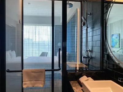 a bathroom with a bed and a sink and a mirror at M Resort & Hotel Kuala Lumpur in Kuala Lumpur