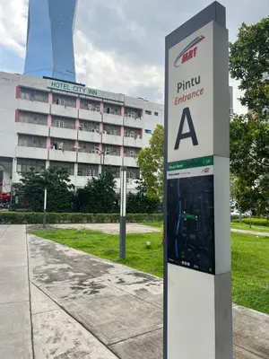 a parking sign in front of a building at Opus Residences Merdeka Tower 118 View in Kuala Lumpur