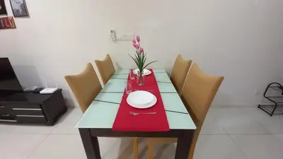 a dining table with a red napkin and a plate on it at Summer Suites Klcc by Malenehom in Kuala Lumpur