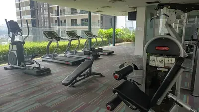 a row of exercise machines in a gym at Summer Suites Klcc by Malenehom in Kuala Lumpur