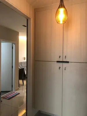 a kitchen with white cabinets and a light fixture at Lucky Continew Residence 1 Bedroom - TRX KL in Kuala Lumpur