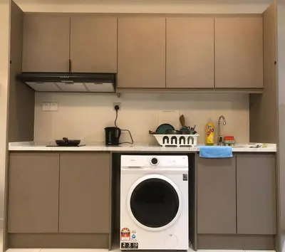 a kitchen with a washing machine on a counter at Lucky Continew Residence 1 Bedroom - TRX KL in Kuala Lumpur
