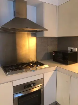 a kitchen with a stove top oven and a microwave at Gorgeous Fairlane 2 Bedrooms - Bukit Bintang KL in Kuala Lumpur