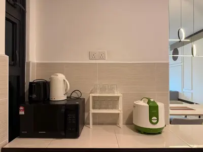 a kitchen with a black microwave and a blender at Legasi Kampung Baru KL Homestay in Kuala Lumpur