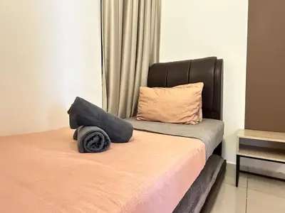 a bedroom with a bed with a black headboard at Legasi Kampung Baru KL Homestay in Kuala Lumpur