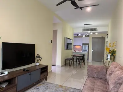 a living room with a couch and a flat screen tv at Legasi Kampung Baru KL Homestay in Kuala Lumpur