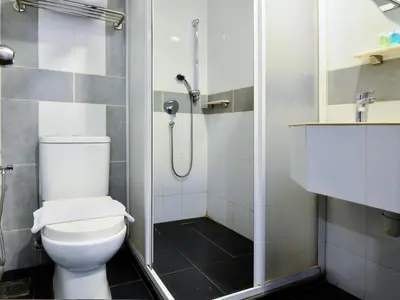 a bathroom with a shower with a toilet and a sink at Palette KL Sentral Station Formerly Scott Hotel in Kuala Lumpur
