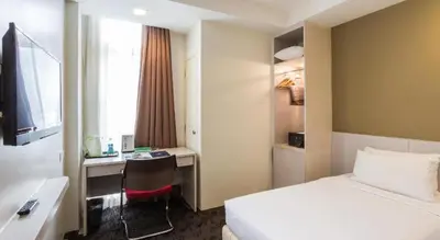 a hotel room with a bed and a desk at Palette KL Sentral Station Formerly Scott Hotel in Kuala Lumpur