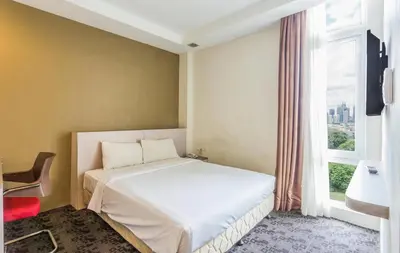 a bedroom with a bed and a large window at Palette KL Sentral Station Formerly Scott Hotel in Kuala Lumpur