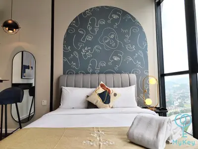 a bedroom with a bed with a black and white wall at Scarletz Suites KLCC by MyKey in Kuala Lumpur
