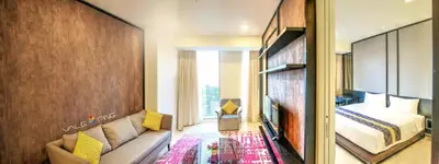 a bedroom with a bed and a couch in a room at Tropicana The Residences KLCC By Luxury Suites in Kuala Lumpur
