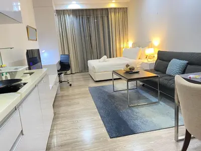 a living room with a couch and a table at Lila Suites One Bukit Ceylon in Kuala Lumpur