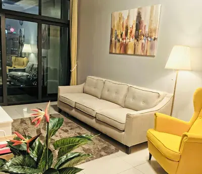a living room with a white couch and a yellow chair at 3 Bedrooms Short Stays Condo at KLCC in Kuala Lumpur