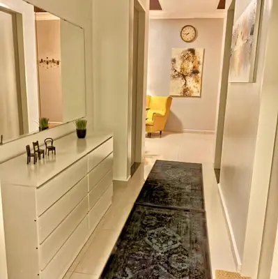 a hallway with a living room with a couch and a rug at 3 Bedrooms Short Stays Condo at KLCC in Kuala Lumpur