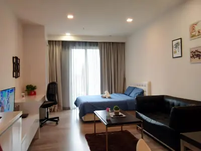 a bedroom with a bed and a living room at City Home Suites Kuala Lumpur City Centre in Kuala Lumpur