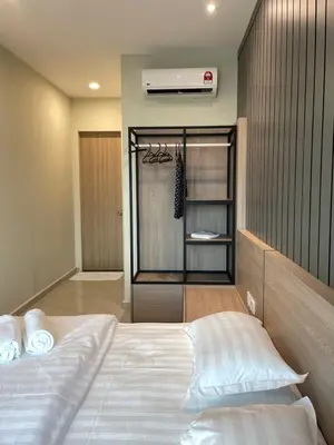 a bedroom with a white bed and a air conditioner at Legasi Kampung Bharu by Tulip in Kuala Lumpur