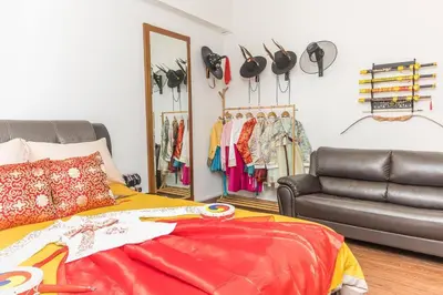 a bedroom with a bed and a leather couch at Fahrenheit88-Korea Theme Bukit Bintang Kuala Lumpur 2R2B 6Pax in Kuala Lumpur