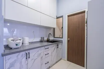 a kitchen with white cabinets and a sink at Peaceful 3-bedroom with Pool 5 pax - Wangsa Maju in Kuala Lumpur