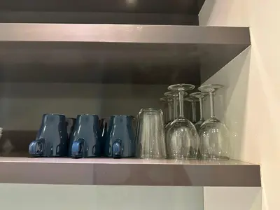 a row of glass bottles sitting on a shelf at Platinum KLCC By Rainbow Suites in Kuala Lumpur