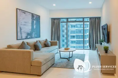 a living room with a couch and a table at Eaton Residences KLCC by Plush in Kuala Lumpur